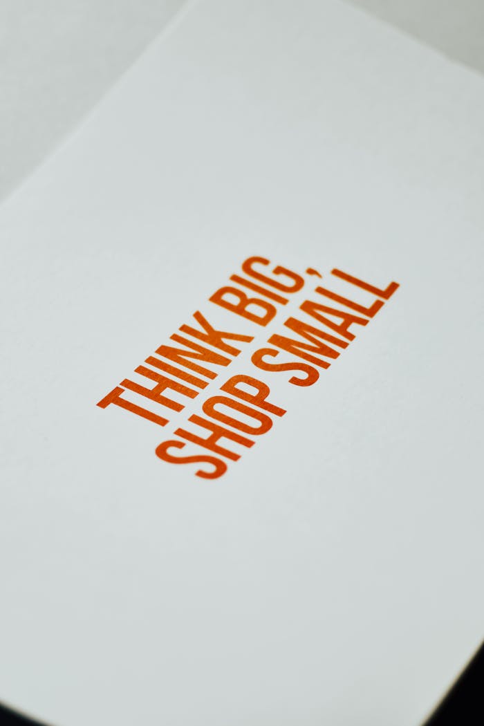 Close-up of paper sign with Think Big, Shop Small for support and strategy.